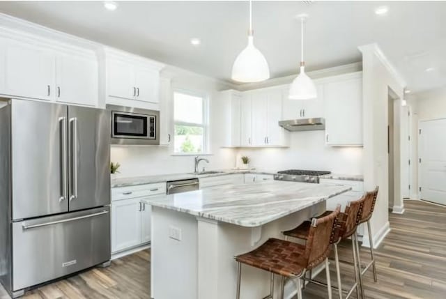 325 Sharp Way, Murfreesboro, TN 37128 - kitchen with appliances with stainless steel finishes, under cabinet range hood, a center island, a breakfast bar, and white cabinetry