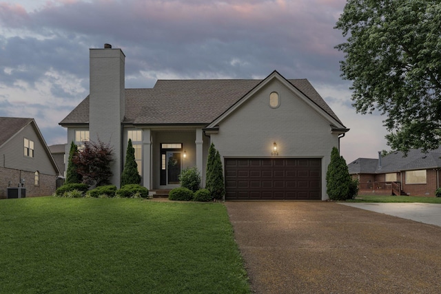 904 Park Crest Ct, Mount Juliet, TN 37122 - view of front of property with concrete driveway, a chimney, cooling unit, a front lawn, and an attached garage