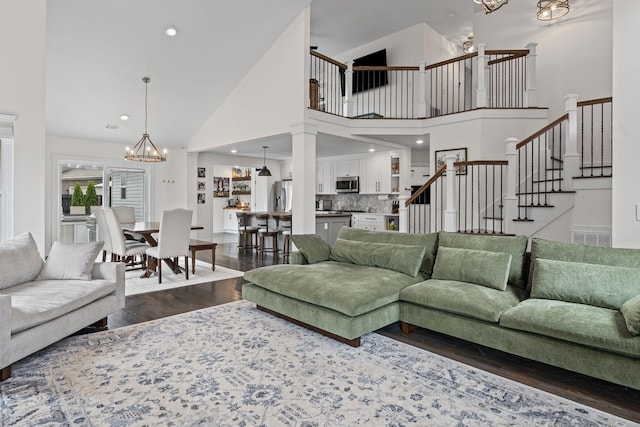 904 Park Crest Ct, Mount Juliet, TN 37122 - living room featuring a chandelier, dark wood-style flooring, stairway, high vaulted ceiling, and recessed lighting