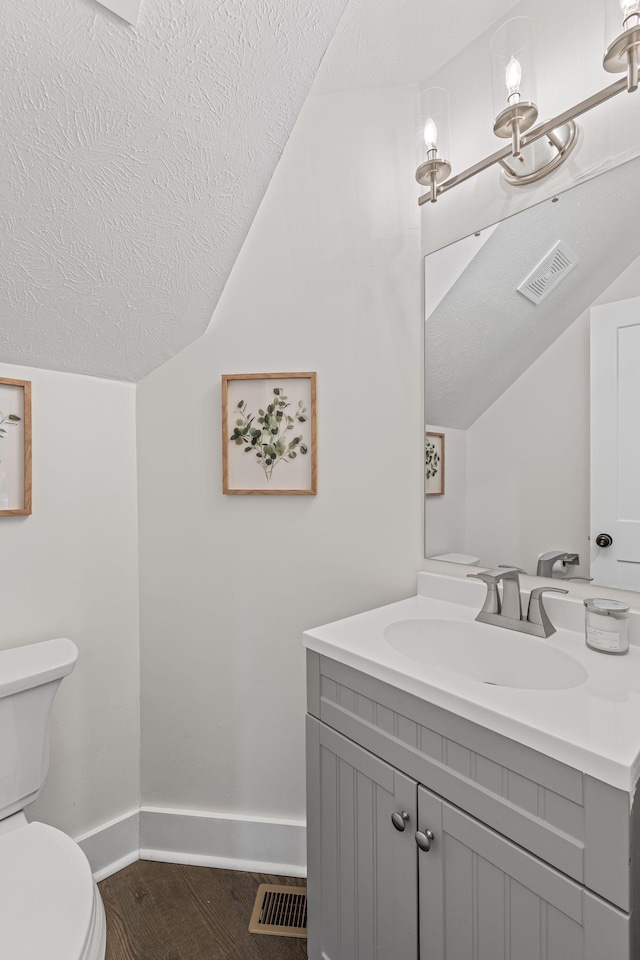 904 Park Crest Ct, Mount Juliet, TN 37122 - half bathroom with baseboards, toilet, vaulted ceiling, vanity, and a textured ceiling