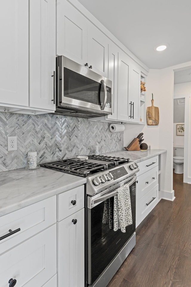 904 Park Crest Ct, Mount Juliet, TN 37122 - kitchen featuring stainless steel appliances, backsplash, dark wood-style flooring, white cabinetry, and light stone counters