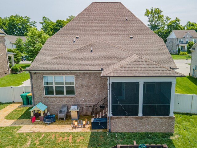 705 Rain Meadow Ct, Spring Hill, TN 37174 - back of house with a gate, a sunroom, brick siding, and a patio