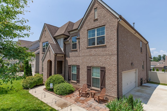 705 Rain Meadow Ct, Spring Hill, TN 37174 - view of front of house featuring a garage, brick siding, and concrete driveway
