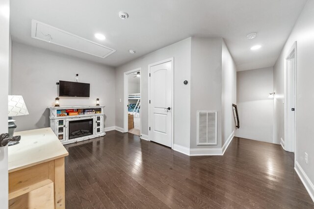 705 Rain Meadow Ct, Spring Hill, TN 37174 - unfurnished living room featuring attic access, dark wood-style floors, and recessed lighting