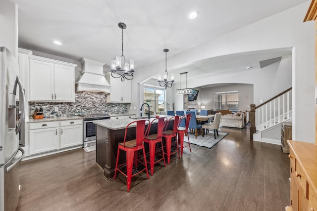 705 Rain Meadow Ct, Spring Hill, TN 37174 - kitchen featuring premium range hood, appliances with stainless steel finishes, a chandelier, open floor plan, and backsplash