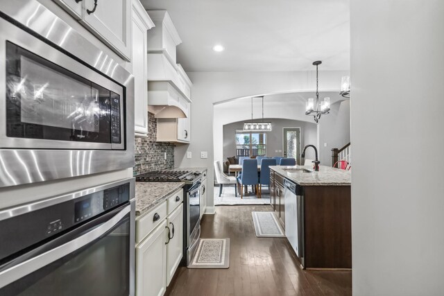 705 Rain Meadow Ct, Spring Hill, TN 37174 - kitchen featuring stainless steel appliances, dark wood finished floors, backsplash, white cabinetry, and light stone counters