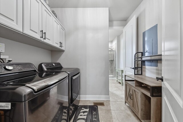 705 Rain Meadow Ct, Spring Hill, TN 37174 - laundry room featuring washing machine and clothes dryer, light tile patterned floors, and cabinet space