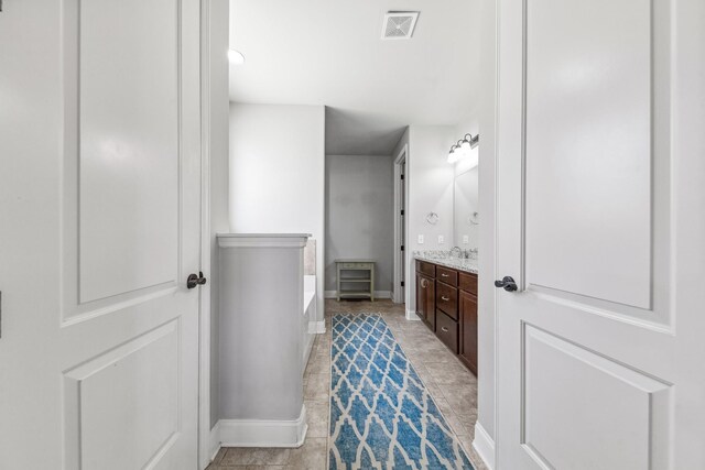 705 Rain Meadow Ct, Spring Hill, TN 37174 - bathroom featuring vanity, a garden tub, and tile patterned flooring