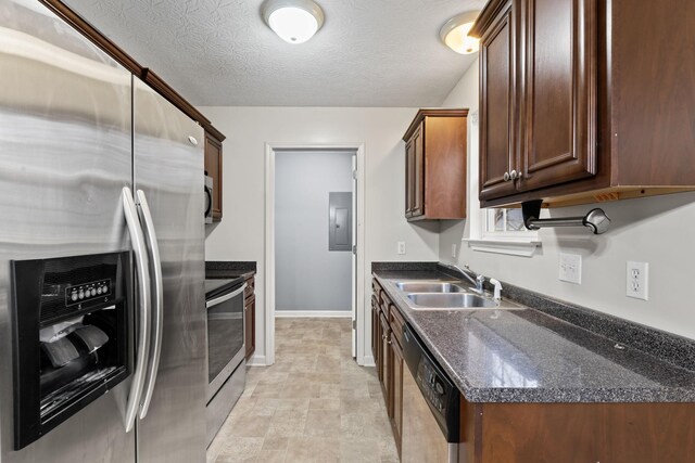 1090 Sugarberry Ln, Springfield, TN 37172 - kitchen featuring stainless steel appliances, a sink, electric panel, baseboards, and dark brown cabinets