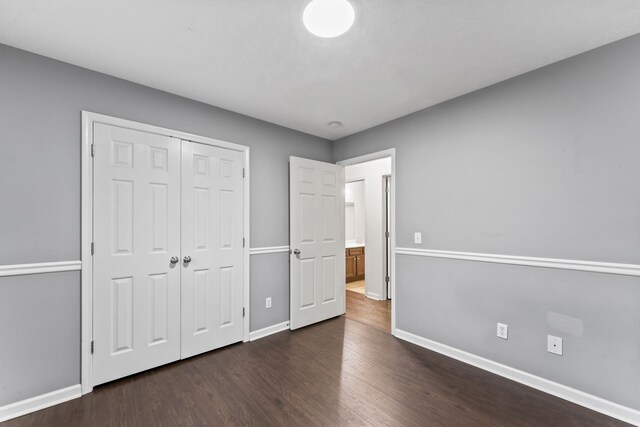 1090 Sugarberry Ln, Springfield, TN 37172 - unfurnished bedroom featuring dark wood-style floors, baseboards, and a closet