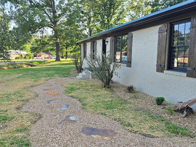 371 Leader Dr, New Johnsonville, TN 37134 - view of property exterior featuring brick siding and a lawn