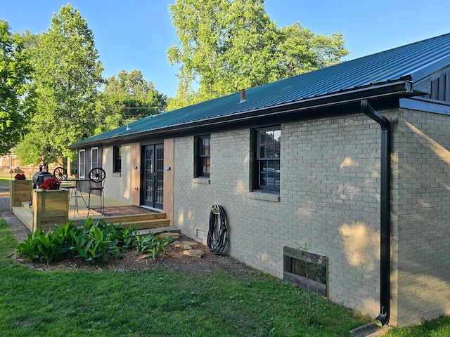 371 Leader Dr, New Johnsonville, TN 37134 - rear view of property featuring a metal roof, a deck, and brick siding