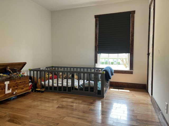 371 Leader Dr, New Johnsonville, TN 37134 - bedroom featuring wood finished floors and a crib
