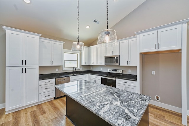 796 N Leath Rd, Portland, TN 37148 - kitchen featuring appliances with stainless steel finishes, white cabinetry, decorative light fixtures, a center island, and high vaulted ceiling