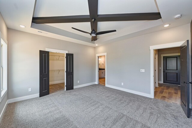 796 N Leath Rd, Portland, TN 37148 - unfurnished bedroom featuring carpet, recessed lighting, baseboards, a spacious closet, and a tray ceiling