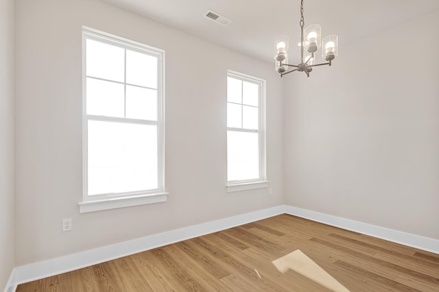 2416 Burton Dr, White House, TN 37188 - empty room with a chandelier, baseboards, and light wood-type flooring