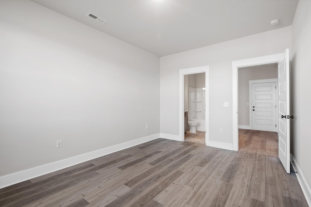 2416 Burton Dr, White House, TN 37188 - unfurnished bedroom featuring wood finished floors, baseboards, and ensuite bathroom