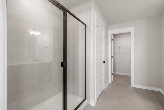 2416 Burton Dr, White House, TN 37188 - bathroom with baseboards, a shower stall, a spacious closet, and tile patterned floors