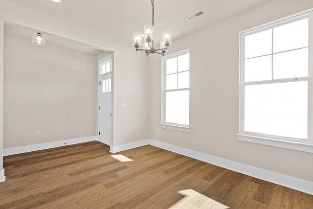 2416 Burton Dr, White House, TN 37188 - unfurnished room with a chandelier, baseboards, and light wood-style floors