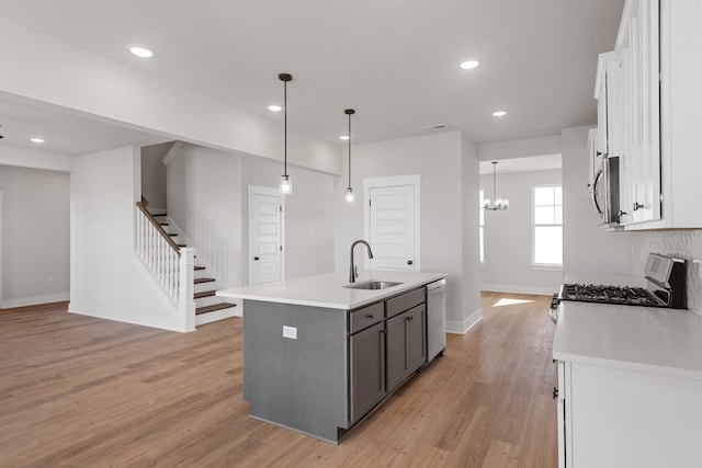 2416 Burton Dr, White House, TN 37188 - kitchen with a sink, appliances with stainless steel finishes, light wood-style floors, white cabinetry, and recessed lighting