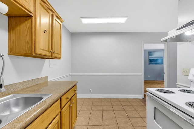 2134 Fairfax Ave Unit A1, Nashville, TN 37212 - kitchen featuring white electric stove, a sink, light countertops, light tile patterned floors, and wall chimney exhaust hood