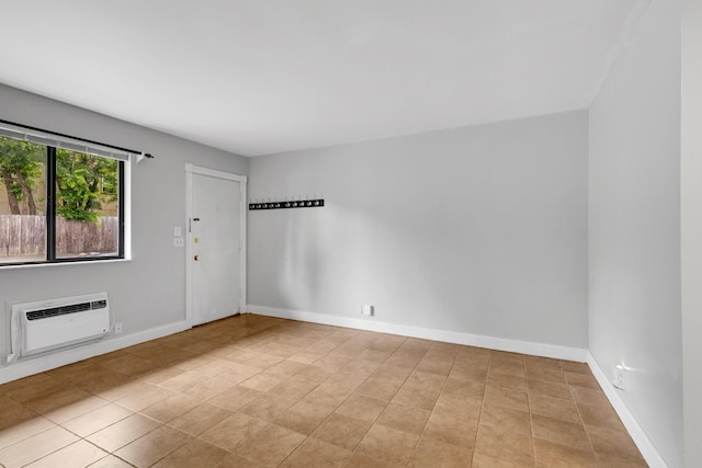 2134 Fairfax Ave Unit A1, Nashville, TN 37212 - spare room featuring a wall mounted air conditioner, tile patterned flooring, and baseboards