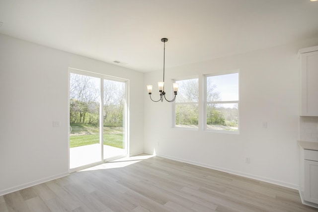 2367 Williamsport Lndg, Columbia, TN 38401 - unfurnished dining area with a chandelier, light wood-style flooring, plenty of natural light, and baseboards