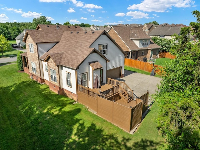 217 Karen Dr, Mount Juliet, TN 37122 - rear view of property with roof with shingles, driveway, a residential view, an attached garage, and a wooden deck