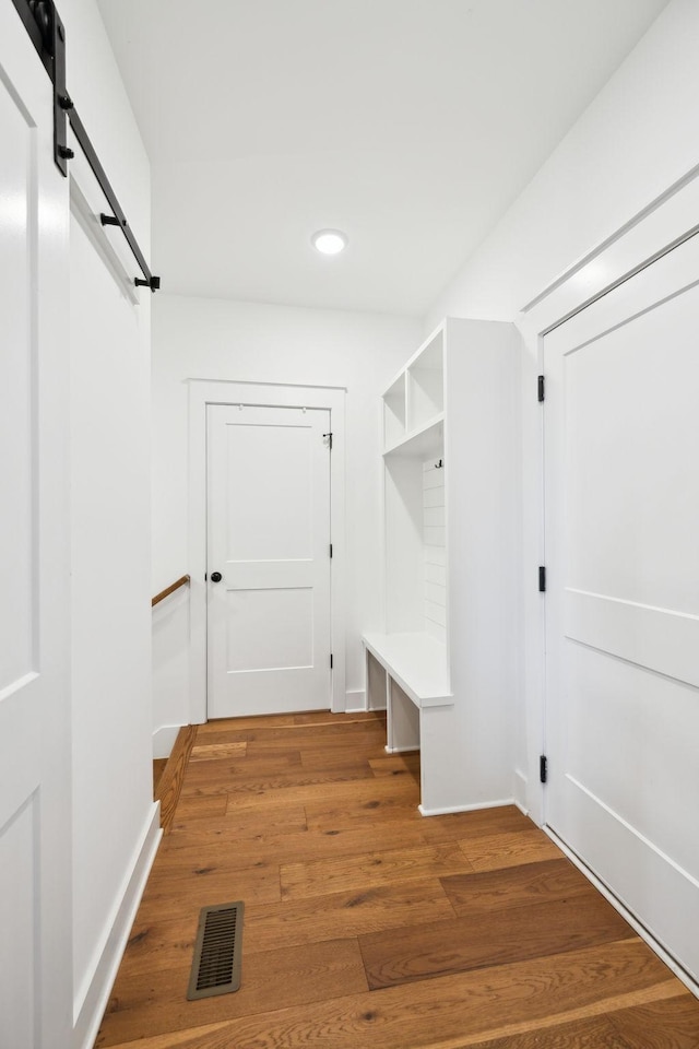 3298 Vinemont Dr, Thompsons Station, TN 37179 - mudroom featuring a barn door, recessed lighting, light wood-type flooring, and baseboards