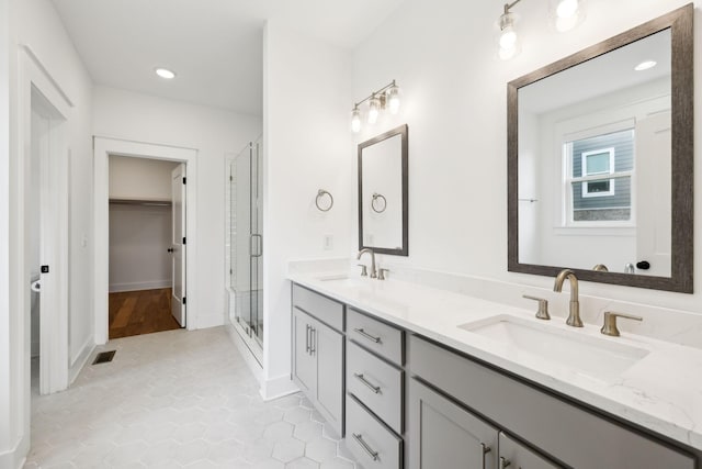 3298 Vinemont Dr, Thompsons Station, TN 37179 - full bath featuring double vanity, a shower stall, tile patterned floors, a spacious closet, and baseboards