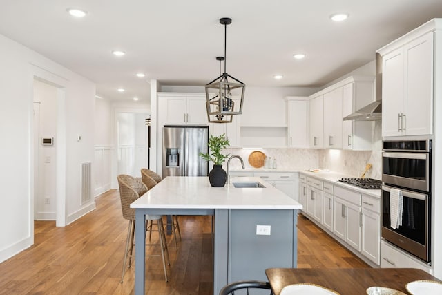 3298 Vinemont Dr, Thompsons Station, TN 37179 - kitchen featuring stainless steel appliances, a sink, a kitchen breakfast bar, white cabinetry, and recessed lighting