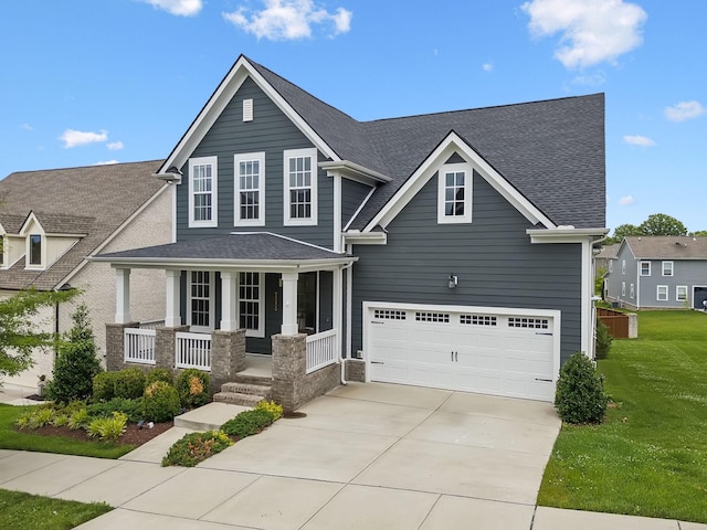 3298 Vinemont Dr, Thompsons Station, TN 37179 - view of front of home with covered porch, a garage, driveway, a front lawn, and roof with shingles