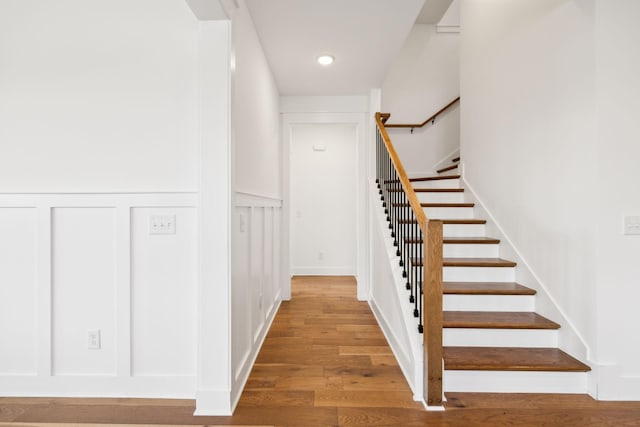 3298 Vinemont Dr, Thompsons Station, TN 37179 - staircase featuring wood finished floors, a wainscoted wall, a decorative wall, and recessed lighting