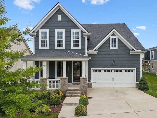 3298 Vinemont Dr, Thompsons Station, TN 37179 - view of front of house featuring a porch, driveway, a shingled roof, and stone siding