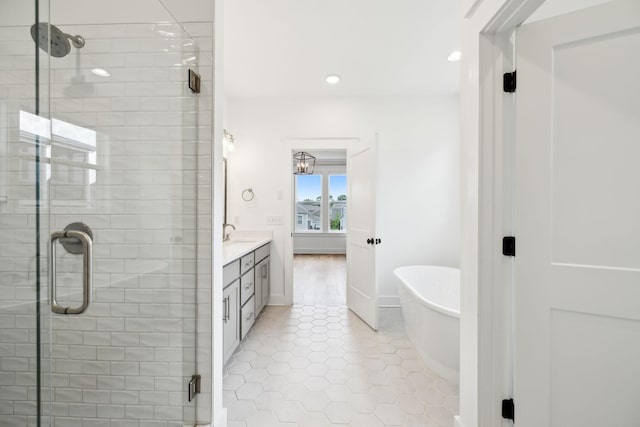 3298 Vinemont Dr, Thompsons Station, TN 37179 - bathroom with double vanity, a stall shower, a freestanding bath, recessed lighting, and tile patterned flooring