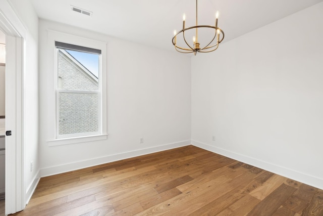 3298 Vinemont Dr, Thompsons Station, TN 37179 - empty room featuring a chandelier, wood-type flooring, and baseboards