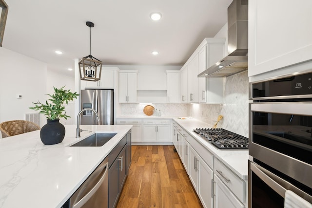 3298 Vinemont Dr, Thompsons Station, TN 37179 - kitchen with appliances with stainless steel finishes, wall chimney exhaust hood, a sink, white cabinets, and recessed lighting