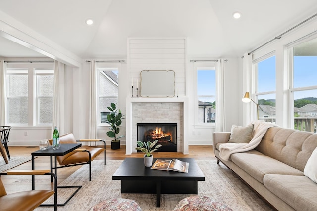 3298 Vinemont Dr, Thompsons Station, TN 37179 - living room featuring a lit fireplace, recessed lighting, wood finished floors, high vaulted ceiling, and baseboards