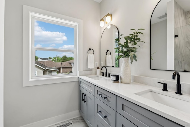 6124 Robertson Ave Unit 3, Nashville, TN 37209 - full bathroom featuring healthy amount of natural light, double vanity, marble look tile flooring, and baseboards