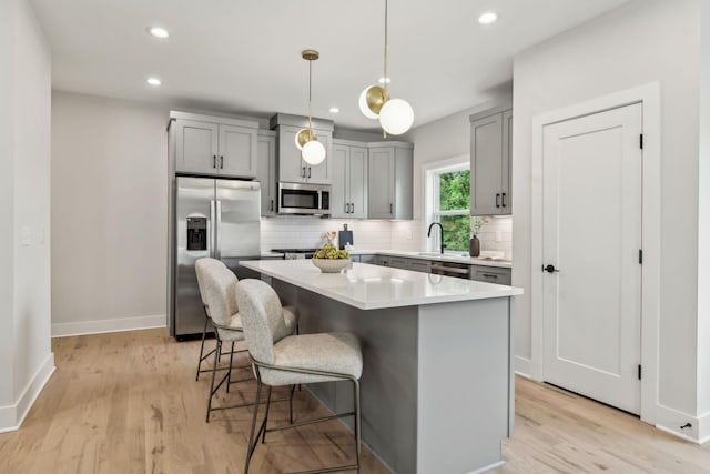 6124 Robertson Ave Unit 3, Nashville, TN 37209 - kitchen featuring stainless steel appliances, gray cabinetry, backsplash, light wood-style flooring, and recessed lighting