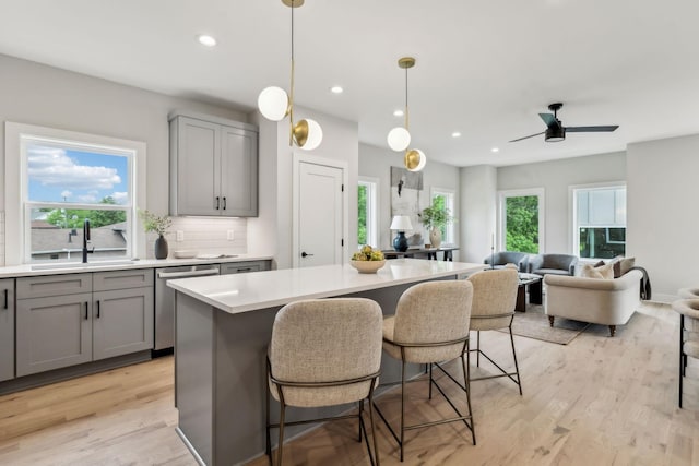 6124 Robertson Ave Unit 3, Nashville, TN 37209 - kitchen featuring gray cabinets, stainless steel dishwasher, a sink, light countertops, and backsplash