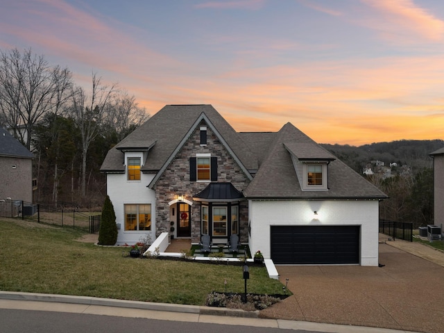 413 Eagle Rdg, Nashville, TN 37209 - french country style house featuring driveway, roof with shingles, stone siding, and stucco siding