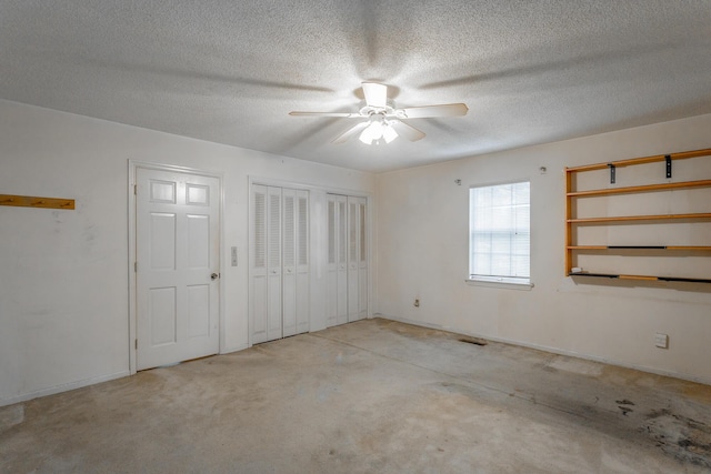 4510 Ravenwood Dr E, Chattanooga, TN 37415 - unfurnished bedroom with two closets, a textured ceiling, baseboards, and a ceiling fan