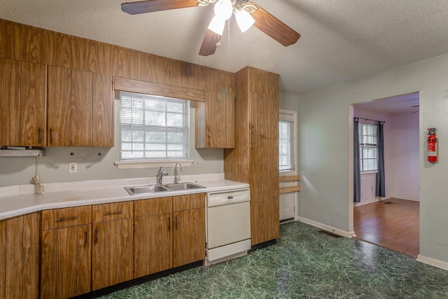 4510 Ravenwood Dr E, Chattanooga, TN 37415 - kitchen featuring dishwasher, a sink, a textured ceiling, plenty of natural light, and light countertops