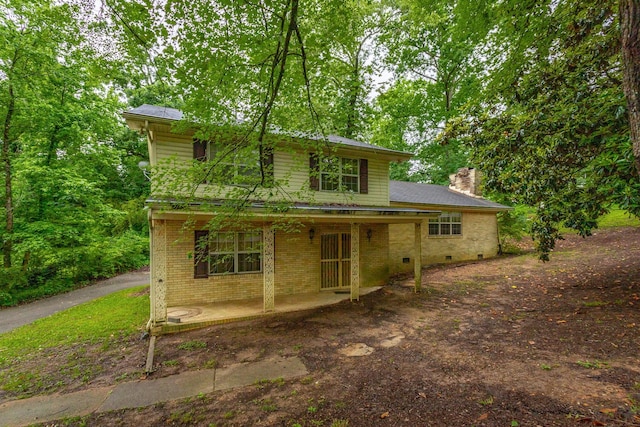 4510 Ravenwood Dr E, Chattanooga, TN 37415 - traditional-style house with a chimney, a porch, and brick siding