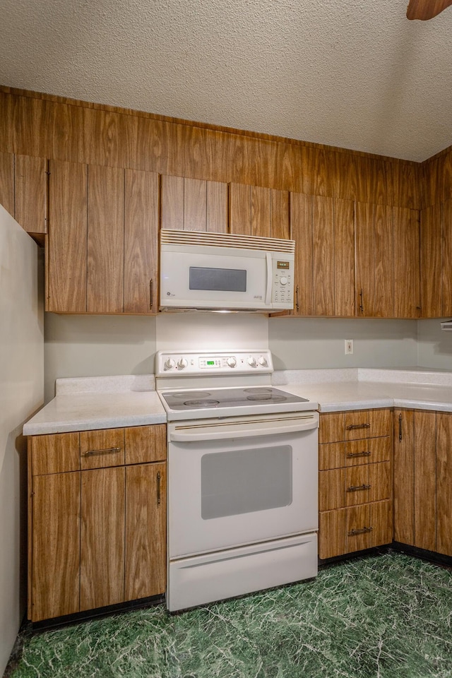 4510 Ravenwood Dr E, Chattanooga, TN 37415 - kitchen featuring white appliances, brown cabinetry, light countertops, and a textured ceiling