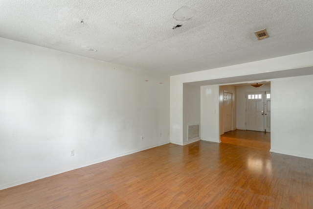 4510 Ravenwood Dr E, Chattanooga, TN 37415 - empty room with wood finished floors, a textured ceiling, and baseboards