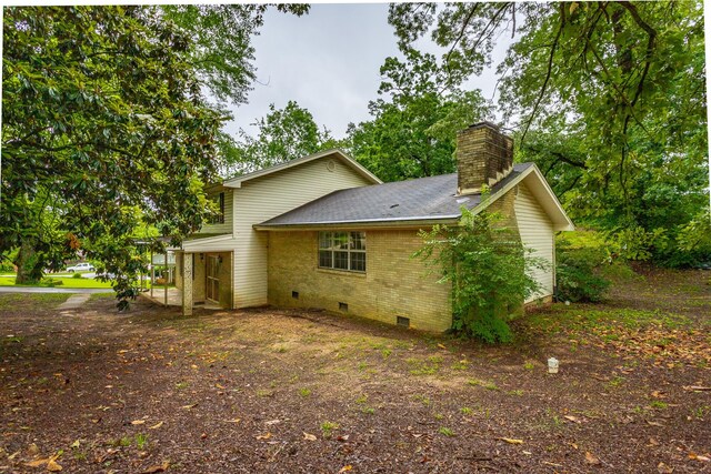 4510 Ravenwood Dr E, Chattanooga, TN 37415 - view of home's exterior featuring crawl space, a chimney, brick siding, and a shingled roof