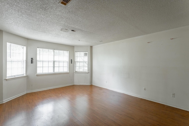 4510 Ravenwood Dr E, Chattanooga, TN 37415 - unfurnished room with wood finished floors, baseboards, and a textured ceiling