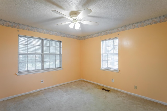 4510 Ravenwood Dr E, Chattanooga, TN 37415 - empty room with a textured ceiling, light carpet, baseboards, and a ceiling fan
